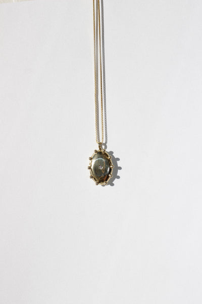 The Sun Locket in Brass + White Sapphire